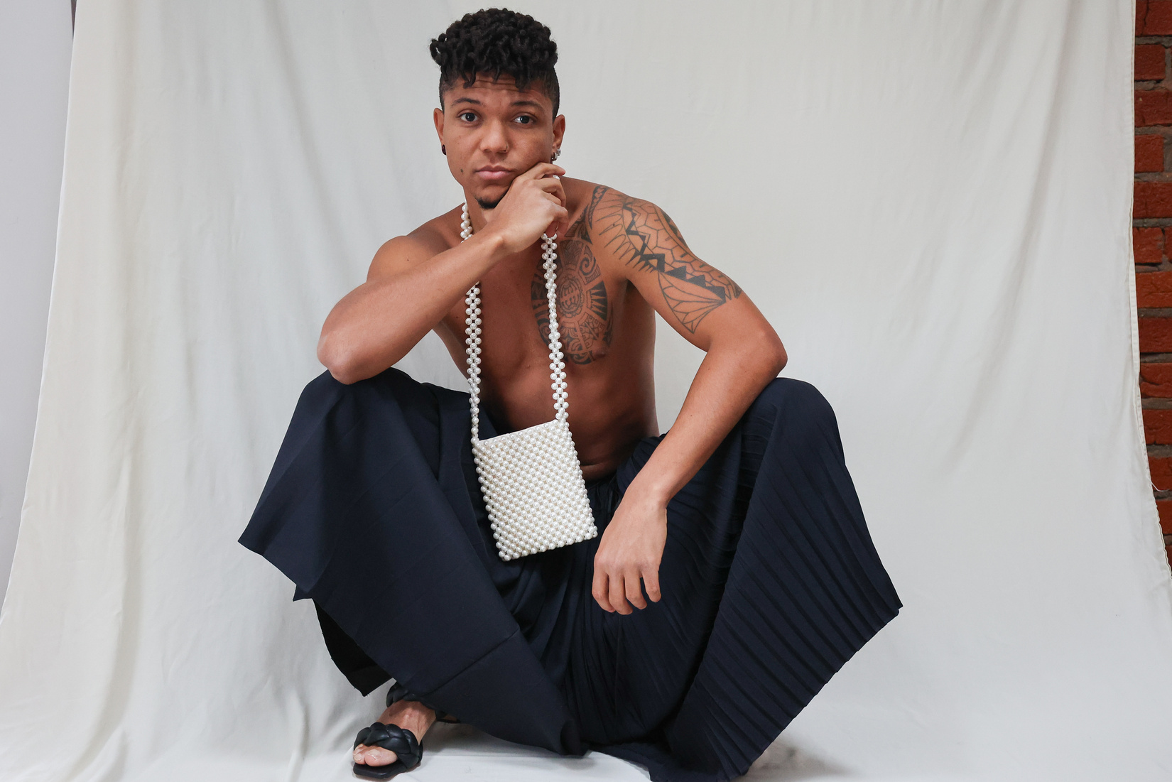 Beautiful Tattooed Man Wearing a Trendy Genderless Skirt 