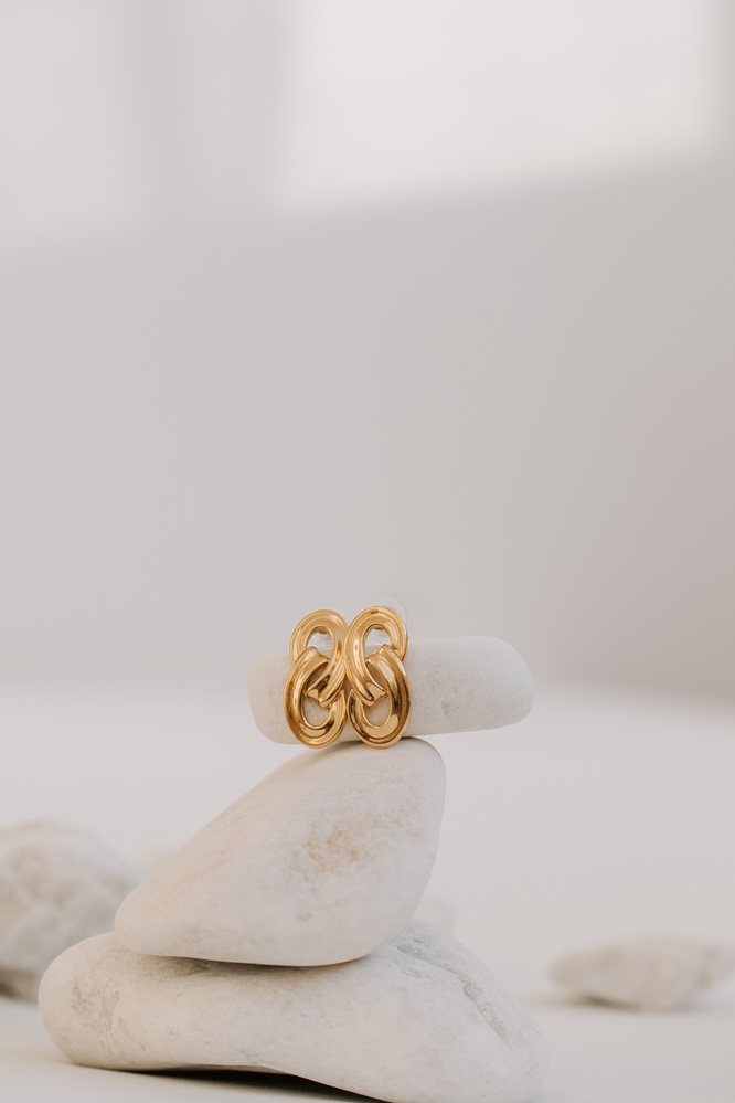 Pair of Gold Earrings on Stack of Rocks